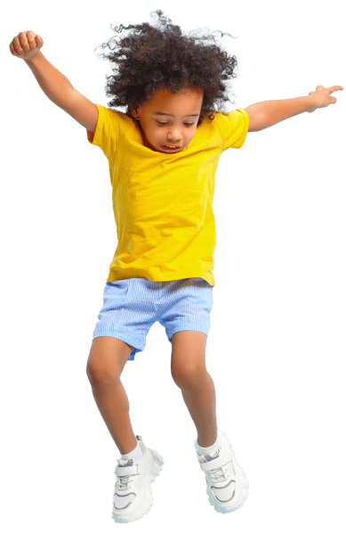 Young boy jumping in the air with hands up